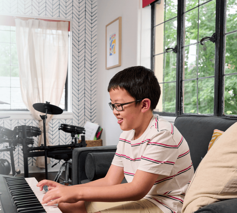 Sam, age 10, living with NF1 PN, playing the piano. Sam is not a Koselugo patient.
