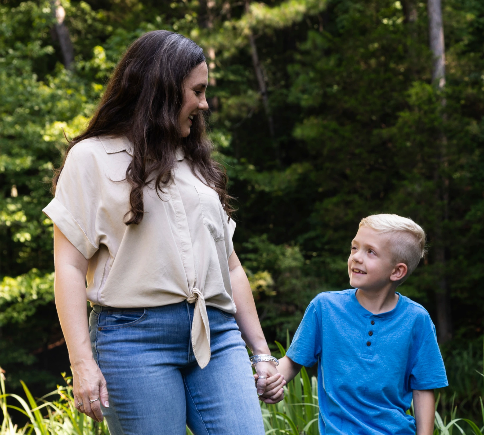 Caleb, age 9, holding hands with his mom. Caleb takes Koselugo for NF1 PN.