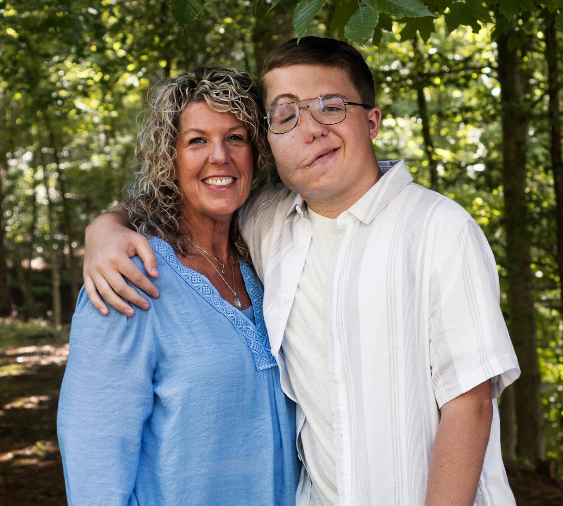 Quentin, age 18, with his arm around his mom. Quentin takes Koselugo for NF1 PN.