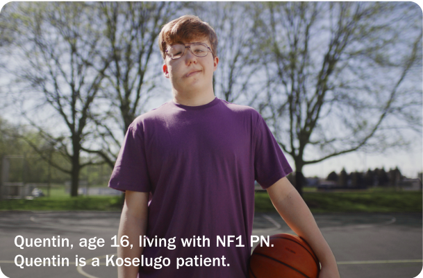 Quentin, a 16-year-old who takes Koselugo for NF1 PN, smiling and holding a basketball