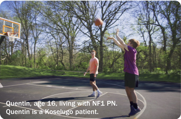 Quentin, a 16-year-old who takes Koselugo for NF1 PN, playing basketball with a friend